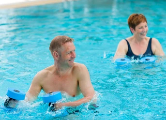 Aqua Fit Wingst Two people exercise with motivation in the blue water during an aqua-fit course.