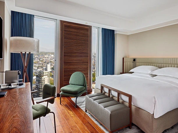 JW Marriott Hotel Frankfurt - Elegant room Elegant room with wooden floor and city view.