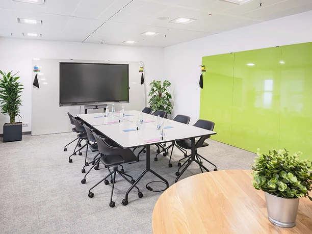 memox Frankfurt Messe - Meetingraum Meetingraum mit Screen und grüner Wand.