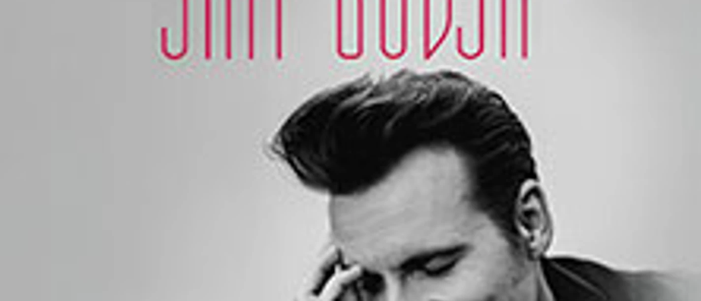 Porträt eines lächelnden Mannes, der auf einem monochromen Hintergrund posiert, begleitet von Text "One Night With Sam Budja".