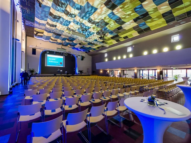 Haus der Begegnung Königstein - Großer Saal Großer Saal mit Stuhlreihen und bunter Decke.