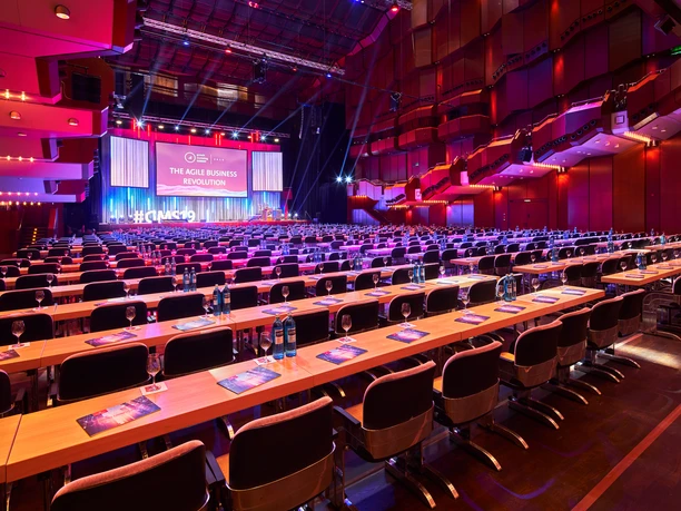 Alte Oper Frankfurt - Great Hall Large hall with conference seating and stage in red light.