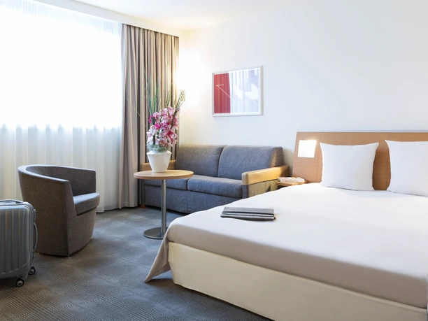 Novotel Frankfurt City - modern guest room Bright, modern guest room with a cozy seating area in the Novotel.