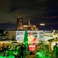 Cologne's highest Christmas market on the SonnenscheinEtage Ein festlich beleuchteter Weihnachtsmarkt auf einer Dachterrasse in Köln mit Blick auf den Dom.A festively illuminated Christmas market on a roof terrace in Cologne with a view of the cathedral.
