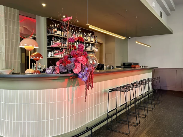 GOOSE Eventspace - Bar Weißer Bartresen mit modernen Barhockern.