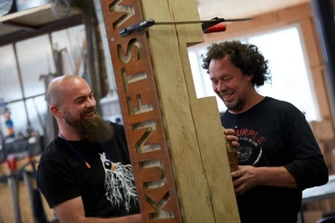 Handwerker beim Bearbeiten der Stele