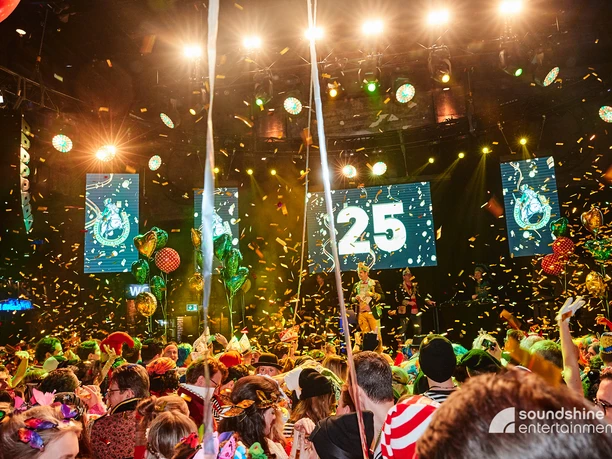 Karneval.jpg Indoor carnival party with costumed people and confetti flying through the air