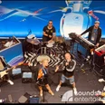 Soundshine Band, Football Lounge, Euro 2024, UEFA.jpg Band Football Lounge plays in jerseys and tracksuits with keyboards, drums and singers on a stage