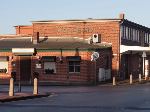 Halle XIV H9754 (c) Helmut Gross_Erlebnis Bremerhaven.jpg Backsteingebäude mit Aufschrift Halle XIV, langgestreckte Fassade und Zufahrtsbereich in Bremerhaven.