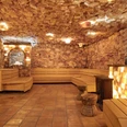 Mediterana Himalaya Salzstollen Blick in eine Sauna mit Salzblöcken an den Wänden und hellen Holzbänken.
