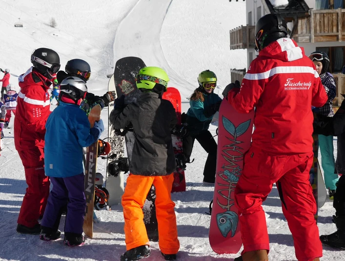 Apprendre à faire ses premiers pas ensemble Kinder erhalten Anweisungen im Snowboard Schnupperkurs Fiescheralp durch SkilehrerChildren receive instructions from ski instructors on the Fiescheralp snowboard taster courseLes enfants reçoivent des instructions de la part de moniteurs de ski lors du cours d'initiation au snowboard à Fiescheralp.