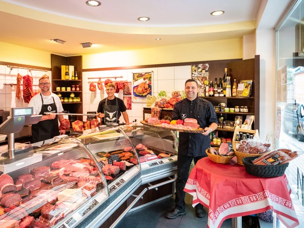 Dirk Hanten und sein Team im Ladenlokal der Landmetzgerei & Catering Hanten in Erkrath Dirk Hanten und sein Team in ihrer Metzgerei in Erkrath, umgeben von frischen Fleischprodukten.