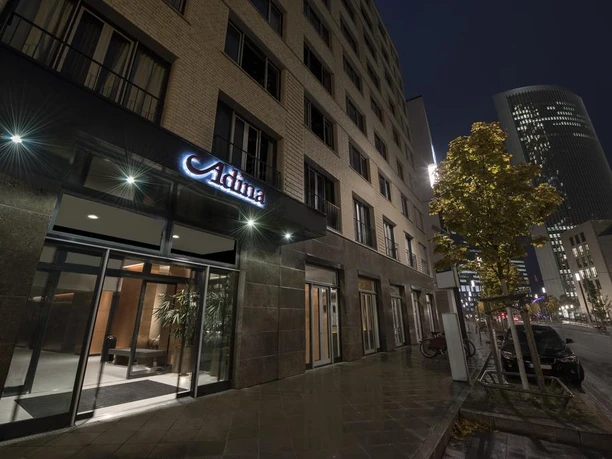Adina Apartment Hotel Frankfurt Westend – Exterior view of the hotel View of the Adina Apartment Hotel Frankfurt Westend at night.
