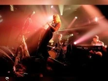 Bühnenauftritt eines Jazzquartetts mit Saxofon, Schlagzeug und Keyboard im farbigen Licht