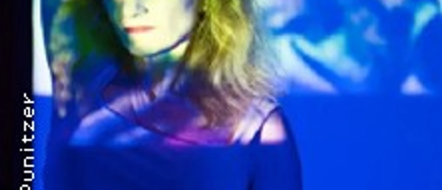 Frau in buntem Licht vor abstrakten Projektionen