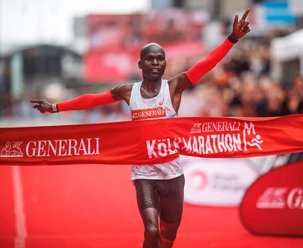 Köln Marathon A runner cheers in front of an audience at the finish of the Cologne Marathon