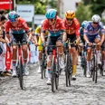Rund um Köln Road cyclists battle for speed and energy on cobblestones in front of cheering spectators