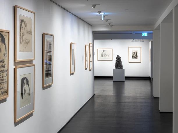 Käthe Kollwitz Museum Bright museum corridor with framed drawings on the walls and a sculpture at the end