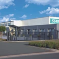 Stanger Außenansicht eines modernen Firmengebäudes mit Stanger-Logo, Zufahrt und Toranlage