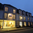 Außenansicht Hotel Appelbaum Beleuchtete Fassade des Hotels Appelbaum bei Nacht mit Eingang, Balkonen und ruhiger Straße.