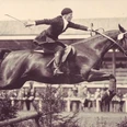 100 Jahre CHIO Aachen_Fotoausstellung (c) Centre Charlemagne.jpg Altes Foto eines Reiters auf seinem Pferd beim Sprung über ein Hindernis auf dem CHIO Gelände in Aachen.