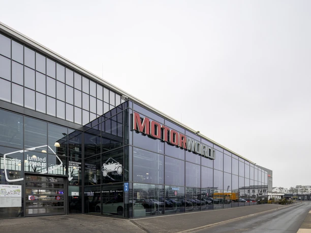 MOTORWORLD Cologne Rhineland Large glass façade of Motorworld Köln with striking red lettering at the entrance
