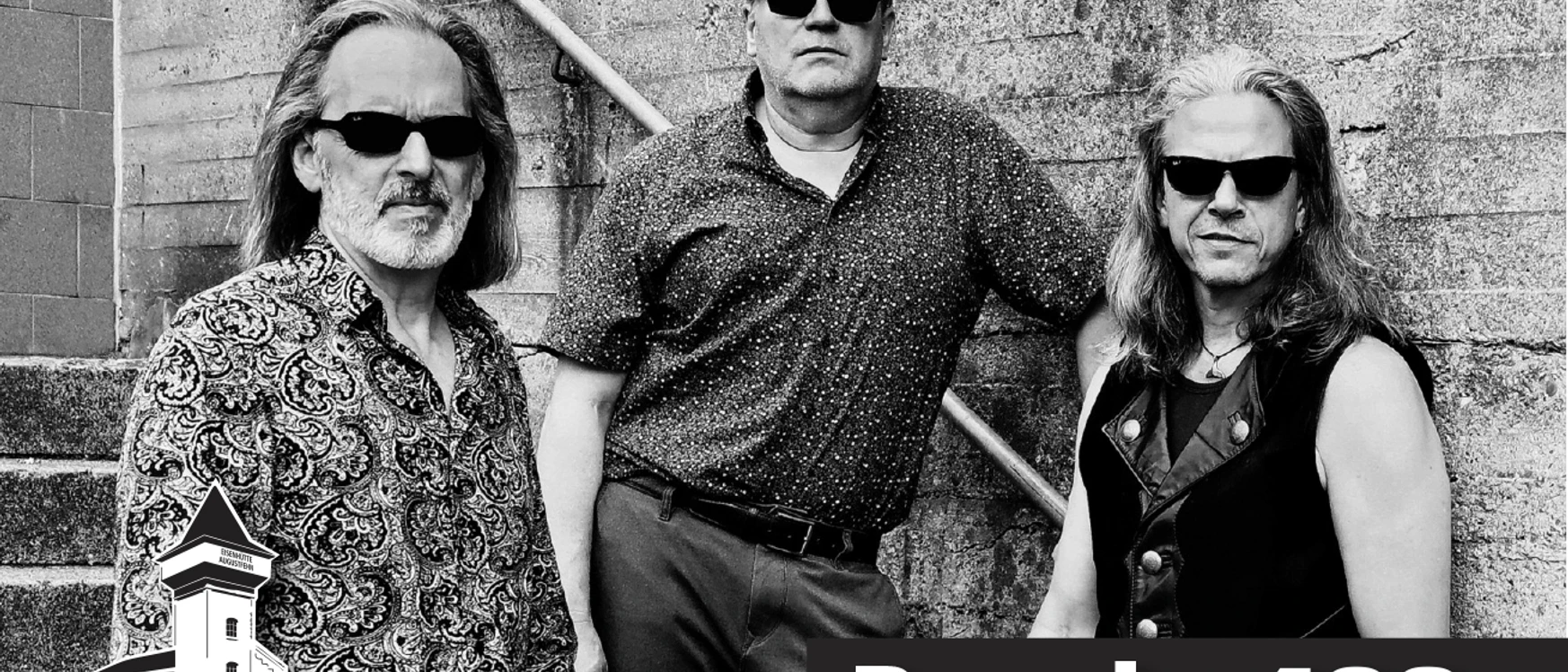 Anzeige Band 409_2026.jpg Drei Musiker mit Sonnenbrillen posieren lässig vor einer Betonwand, darunter Schriftzug Band 409.