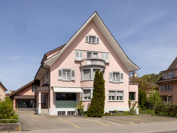 Aussenansicht des Hauses der Ferienwohnung Roof Top in Willisau mit Parkplatz und Umgebung