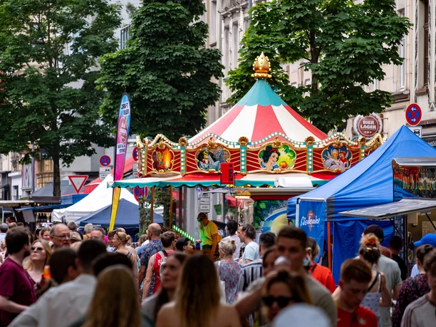 Südstadtfest Cologne Colorful street festival with crowds and a nostalgic carousel between stalls