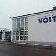 2026_Betriebsbesichtigung_Voith (2)_HD_16zu9.jpg Eingangsbereich des Voith-Werks in Salzgitter mit Firmenlogo und wehenden Fahnen an einem Wintertag
