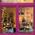 wine&glory Kiosque & ice cream parlor Pink-framed shop window with densely arranged wine bottles and shelves in the interior