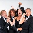 LaLeLu, a cappella comedy quartet Four elegantly dressed people pose together in a humorous and playful scene.