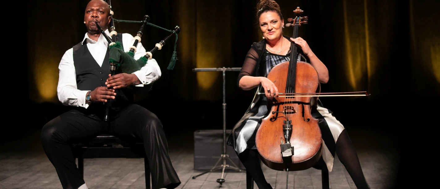 Two musicians in a harmonious interplay of bagpipes and cello.