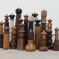 Pepe pepper mills Group of differently shaped wooden pepper mills in a dense arrangement.