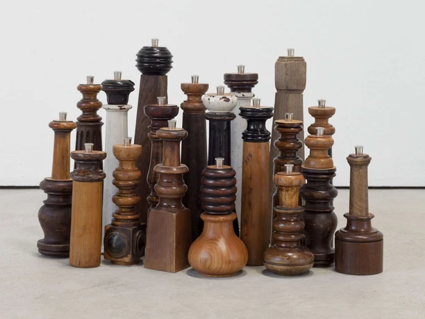 Pepe pepper mills Group of differently shaped wooden pepper mills in a dense arrangement.