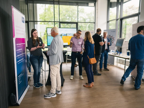 aquarium Large, bright room with people at information stands