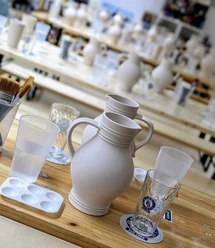 Unpainted Bembel jug on table with brushes in studio