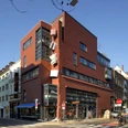 Walther König bookstore Brick building on a street corner with a large bookshop and glazed elements.