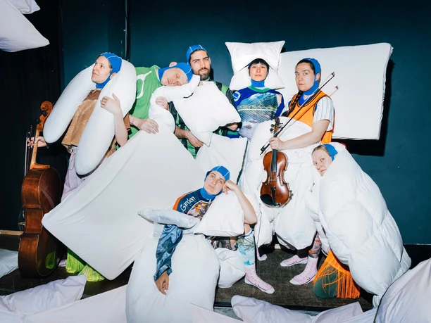 Ensemble uBu Group in imaginative cushion costumes with instruments on a stage area
