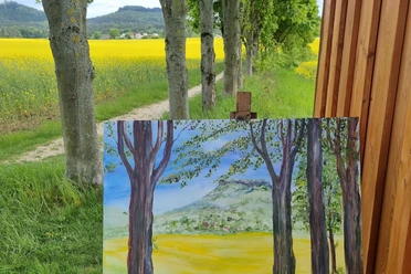 Draussen malen Sächsische-Schweiz mit Yvonne Brückner ein angefangenes Bild auf Staffelei im Vordergrund, Bäume, Weg und Rapsfeld. Im Hintergrund der Ort Gohrisch mit Tafelbergen.