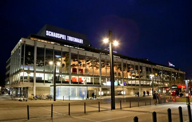 Schauspiel Frankfurt - Facade Schauspiel Frankfurt theatre at night at Willy-Brandt-Platz with tram