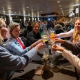 Evening event Group raises glasses at a festively laid table in a lively ship restaurant.