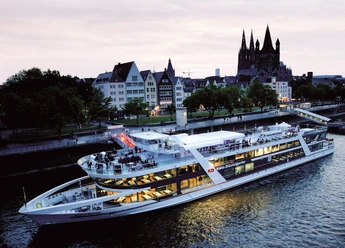 All-inclusive evening trip to Cologne Evening passage along the Rhine on a modern passenger ship against the backdrop of Cologne's historic old town