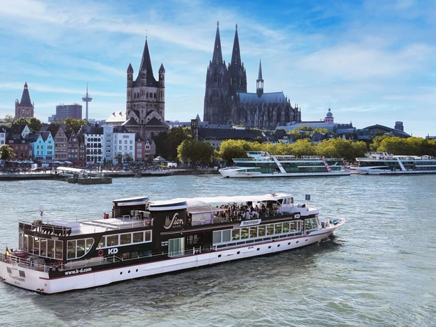 Panorama tour Cologne Passenger ship on the Rhine in front of Cologne's old town with striking church towers.