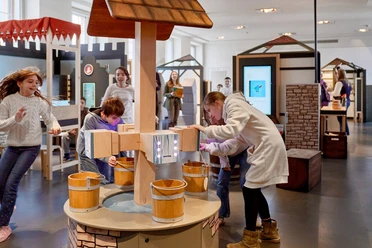 Children at replica fountain in exhibition hall
