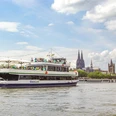 The Kölntourist passenger boat trip on the Rhine in Cologne Excursion boat on the Rhine in front of Cologne's skyline with cathedral and riverside buildings