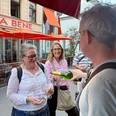A Delightful City Tour Group tasting wine in the street area with red awnings