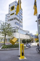 ADAC bike service station Yellow ADAC bike service station in front of the multi-storey ADAC building with flags and bicycles.