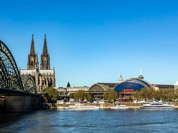Musical Dome on the banks of the Rhine View of the Rhine with Hohenzollern Bridge, Cologne Cathedral and the blue Musical Dome under a clear sky