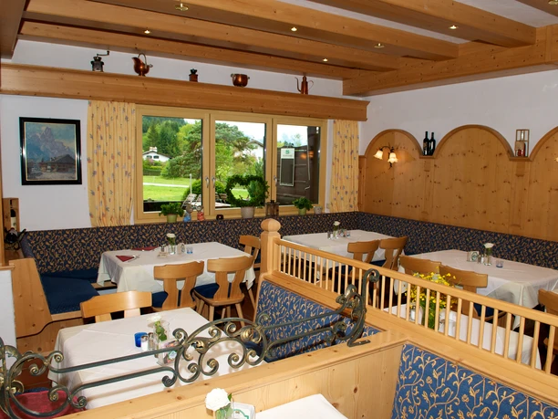 Da Nico in Farchant - Innenbereich der Pizzeria Urige Gaststube mit Eckbänken, Holzstühlen und Tischen mit wei0en Tischdecken